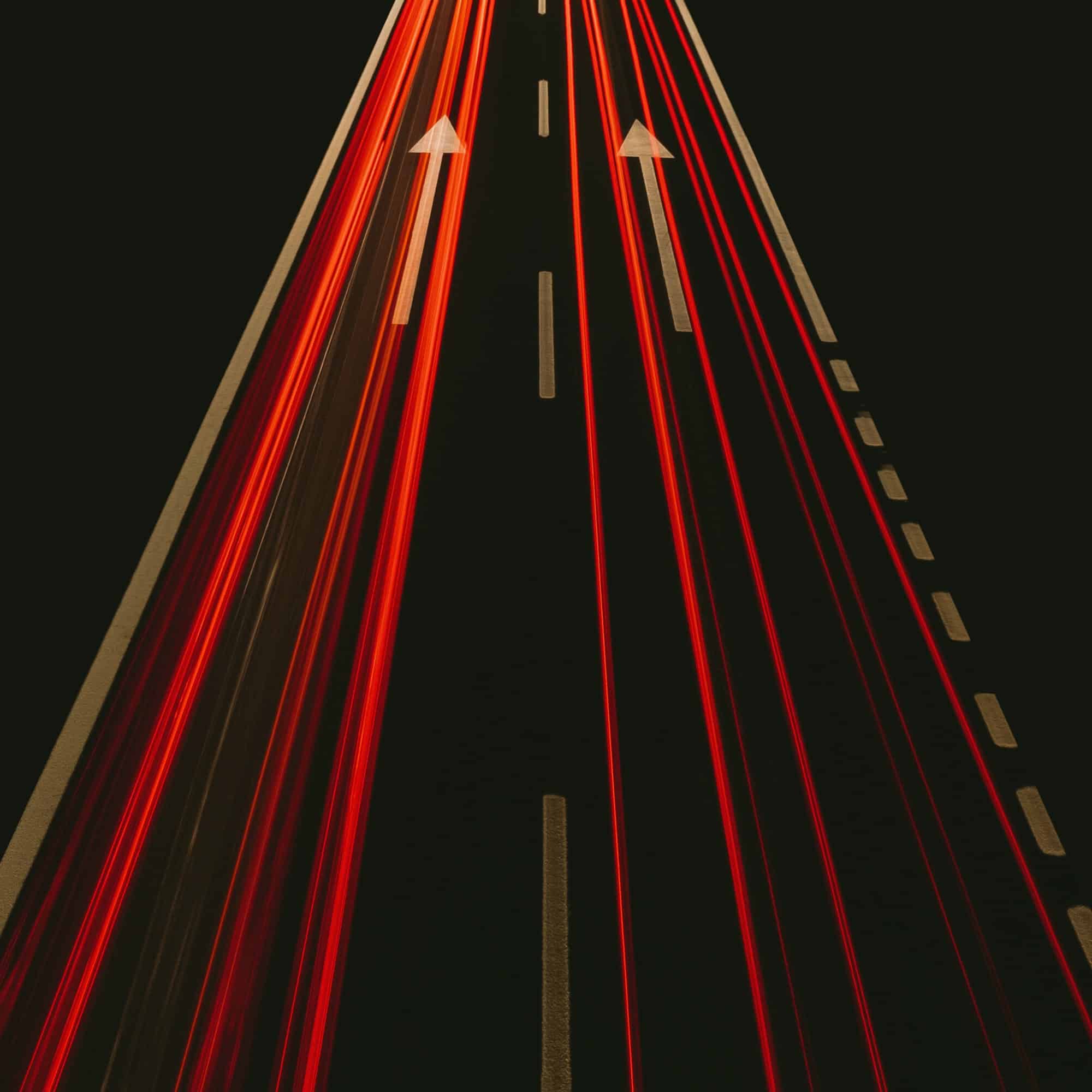 vertical high angel shot of car lights on a highway in long exposure